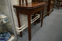 A mahogany fold over tea table.