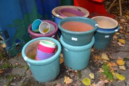 A quantity of glazed plant pots.