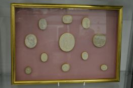 A collection of plaster intaglios in two framed and glazed cases.