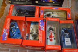 Six boxed Porsche racing cars.
