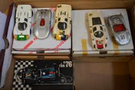 A collection of boxed Porsche racing cars.