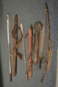 Various African swords with leather scabbards together with a bow and arrows.
