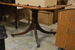 Mahogany tilt top dining table.