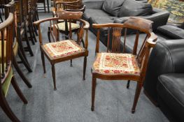 Two Edwardian inlaid mahogany corner armchairs.