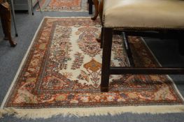 An Indian rug, cream ground with floral decoration 145cm x 95cm.