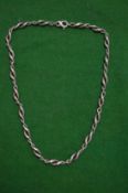 A silver curb link necklace.