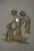 An unusual relief cast bronze figural plaque.