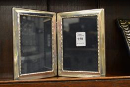 A folding silver photograph frame.