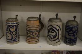 Four German salt glazed beer steins.