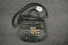 A ladies green leather handbag.