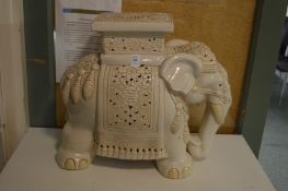 A cream pottery elephant stand.