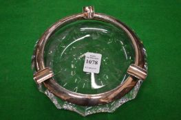 A silver mounted cut glass ashtray.