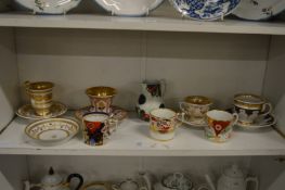 A gilt decorated cabinet cups and saucers and other decorative china.