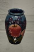 A small Moorcroft vase with original box.