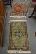 Two small Persian design rugs, one green ground the other red each 100cm x 63cm.