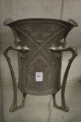 A large Continental art nouveau style pewter vase on four curving supports.