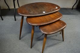 A nest of ercol dark elm coffee tables.