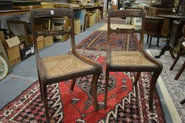 A pair of 19th century mahogany and canework seated dining chairs.