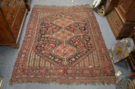 A Persian Qashqai rug with stylised decoration. 180cm x 135cm