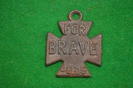 An unusual cast metal badge, one side embossed 'for brave deeds' the other side 'liar'.