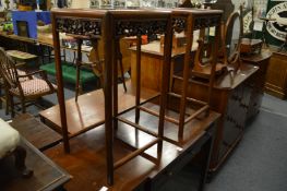 A pair of Chinese square shaped stands with carved and pierced frieze.