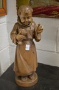 Carved wood figure of a standing monk.