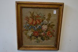 A woolwork picture depicting flowers in a decorative gilt frame.