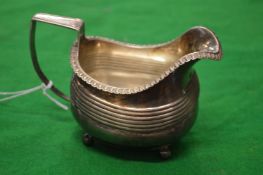 A silver milk jug.