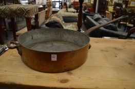A large copper frying pan.
