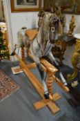 A good large dapple grey rocking horse on pine base.