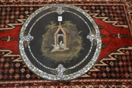 A good Victorian ebonised tripod table, the circular top painted with doves by a dovecote