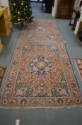 A pair of Persian rugs, rust ground with floral decoration each 195cm x 135cm.
