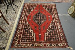 A Persian Hamadan rug red ground with stylised decoration 200cm x 140cm.