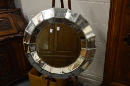 A decorative modern Venetian style circular segmented wall mirror.
