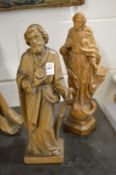 Two carved wood religious figures.