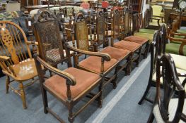 A set of five oak high back dining chairs, one with arms.
