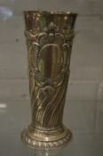A large silver tapering vase with embossed and engraved decoration.