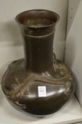 A large Chinese bronze vase decorated with a dragon.