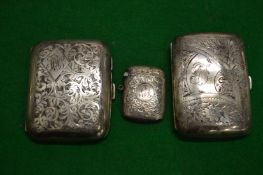 Two engraved silver cigarette cases and a vesta case.
