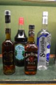 Four various bottles of drink to include Jim Beam Black.