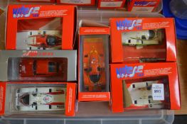 Six boxed Porsche racing cars.