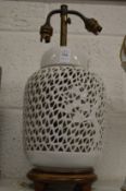 A Chinese blanc de chine lamp base with pierced decoration.