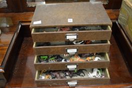 A small chest containing toy horses etc.