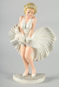 A PAINTED CAST IRON MARILYN MUNROE DOORSTOP. 13ins high.