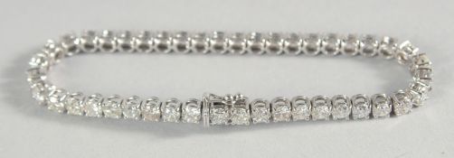 AN 18CT GOLD AND DIAMOND LINE BRACELET, approx. 10.5ct.