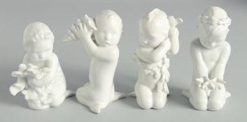 A SET OF FOUR BLUE AND WHITE PORCELAIN CUPIDS, Nos. 2264, 2266, 2265 & 2267. 4ins high.