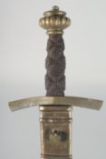 A LARGE GERMAN EXECUTIONERS SWORD with fullered broad blade with brass mounts. Signed: AUG
