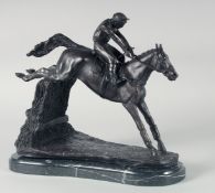 A BRONZE HORSE AND JOCKEY, OVER THE FENCE, on a marble base. 12ins high.