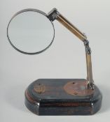 A MAGNIFYING GLASS on a wooden stand. 7.5ins.