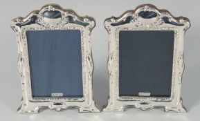 A PAIR OF SILVER FRAMED UPRIGHT PHOTOGRAPH FRAMES 8ins x 5.75ins.